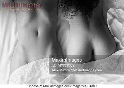 Sexy lesbian couple lying together on bed sheets sensual...... preview image