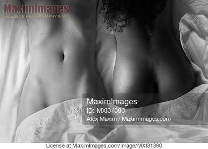 Sexy interracial lesbian couple lying together in bed...... preview image
