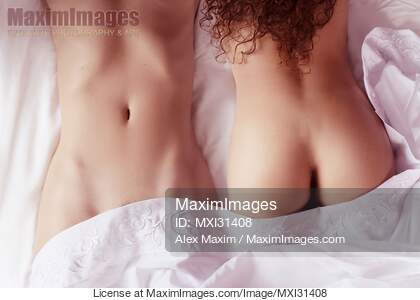 Sexy lesbian couple two women lying together on bed sheets...... preview image