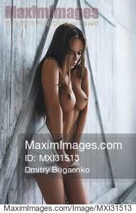 Sexy beautiful woman standing topless taking off her...... preview image