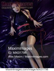 Sensual boudoir portrait of a woman lying on bed in a slick...... preview image
