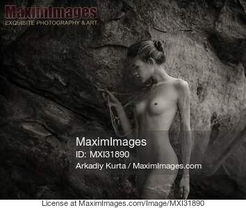 Nude woman in a cave with her naked body wrapped in a cobweb... preview image