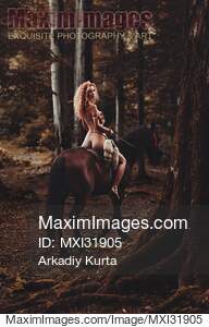 Half-naked young woman riding a horse in the forest... preview image