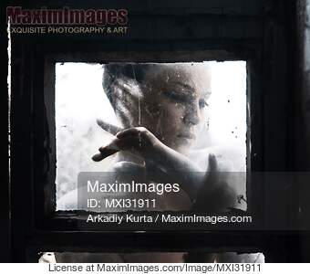 Dramatic expressive portrait of a woman face behind a...... preview image