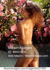 Beautiful woman with shiny oily sun tanned skin standing...... preview image