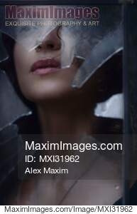 Woman face visible through a hole in a window looking...... preview image