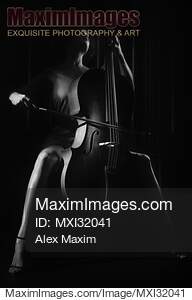 Woman passionately playing cello Dramatic dark contrast...... preview image
