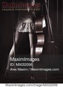 Legs of a sexy young woman in a night gown holding a cello...... preview image