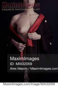 Mysterious woman with white skin taking off black and red...... preview image