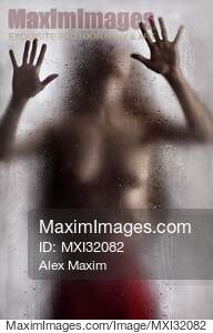 Half nude woman leaning against the glass with man hands...... preview image