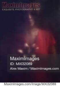 Mysterious dark portrait of a woman looking at a lily...... preview image