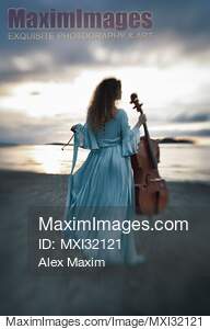 Atmospheric portrait of a woman in a vintage dress standing...... preview image