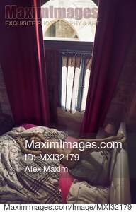 Beautiful nude woman lying on a bed naked with her legs on...... preview image