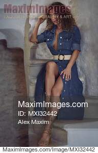 Sexy young woman in unbuttoned denim dress revealing her...... preview image