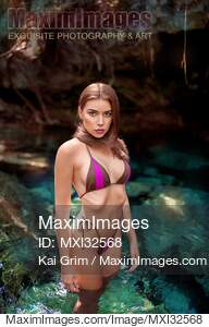Beautiful sexy woman in bikini swimsuit standing in crystal...... preview image