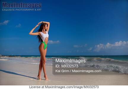 Sexy sun-tanned woman in fashion bathing suit on white...... preview image
