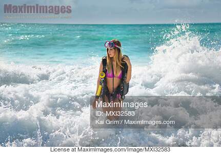 Pretty blond woman bathing in bikini swimsuit and swim vest...... preview image