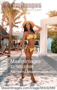 Glamorous a sexy sun-tanned woman in a bikini swimsuit and...... preview image