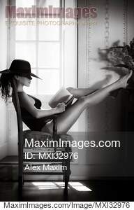 Woman with sexy legs in fashion swimsuit and elegant hat...... preview image