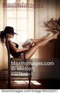 Woman with sexy legs in fashion swimsuit and elegant hat...... preview image