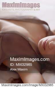 Woman lying in bed with her dress open on her chest Sensual...... preview image