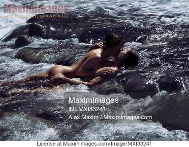 Sensual romantic nude couple in an embrace, kissing, making...... preview image