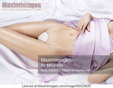 Sexy half-nude woman with sensual curves lying on white...... preview image