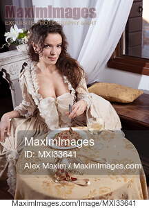 Beautiful elegant lady in vintage carnival dress eating...... preview image