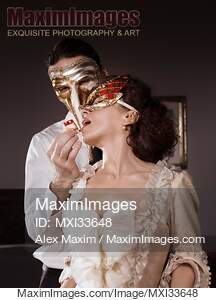 Sensual couple portrait of masked Casanova man seducing...... preview image