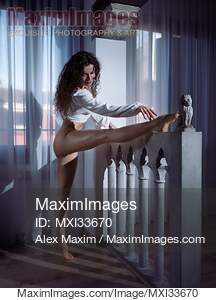 Beautiful half-naked young woman dancer stretching her sexy...... preview image