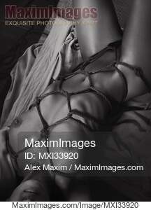 Beautiful nude woman lying on tatami mats tied up with...... preview image