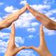 Symbol home made by hands over blue sky... (thumbnail)