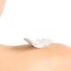 White feather on bare woman shoulder... (thumbnail)