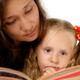 Woman reading a book with a child... (thumbnail)