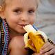 Portrait of child eating a banana... (thumbnail)