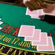 Croupier Dealing Out the Cards at a Blackjack Table... (thumbnail)