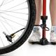 Young Woman Inflating Bicycle Tire... (thumbnail)