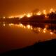 City lights reflecting in river water on foggy night... (thumbnail)