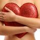 Woman holding red heart to her chest... (thumbnail)