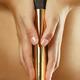 Woman Holding a Gold Vibrator... (thumbnail)