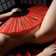 Beautiful naked asian woman covering her body with a red fan... (thumbnail)
