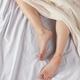 Bare Feet of Woman in Bed... (thumbnail)