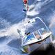 Teenage Girl Riding Wakeboard Behind Motorboat... (thumbnail)