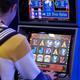 Person Playing Slot Machine in Casino... (thumbnail)