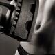 Woman holding antique flat iron in front of her bare stomach... (thumbnail)