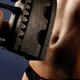 Woman holding antique flat iron in front of her stomach... (thumbnail)