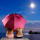 Two Women sitting together on a shore under umbrella... (thumbnail)