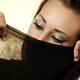 Beautiful Woman Covering Her Face with a Black Scarf... (thumbnail)