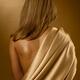 Young woman back covered with golden fabric... (thumbnail)