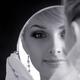 Portrait of young bride looking in a mirror... (thumbnail)